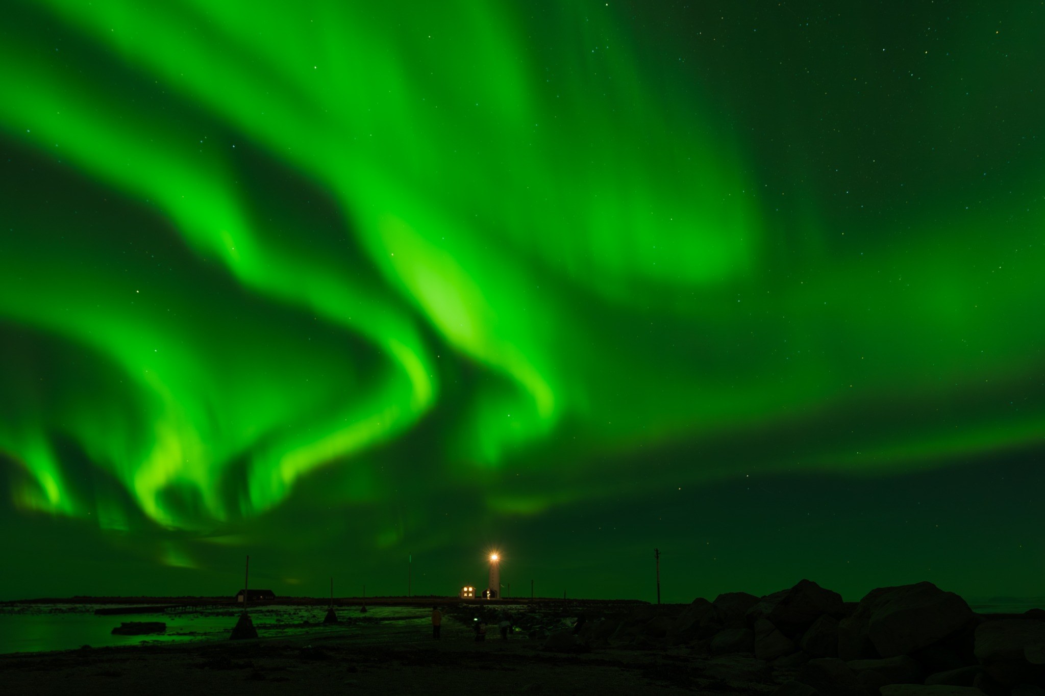 Aurora over a coastal landscape